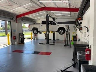 A customer's vehicle on a lift at Coopers Garage