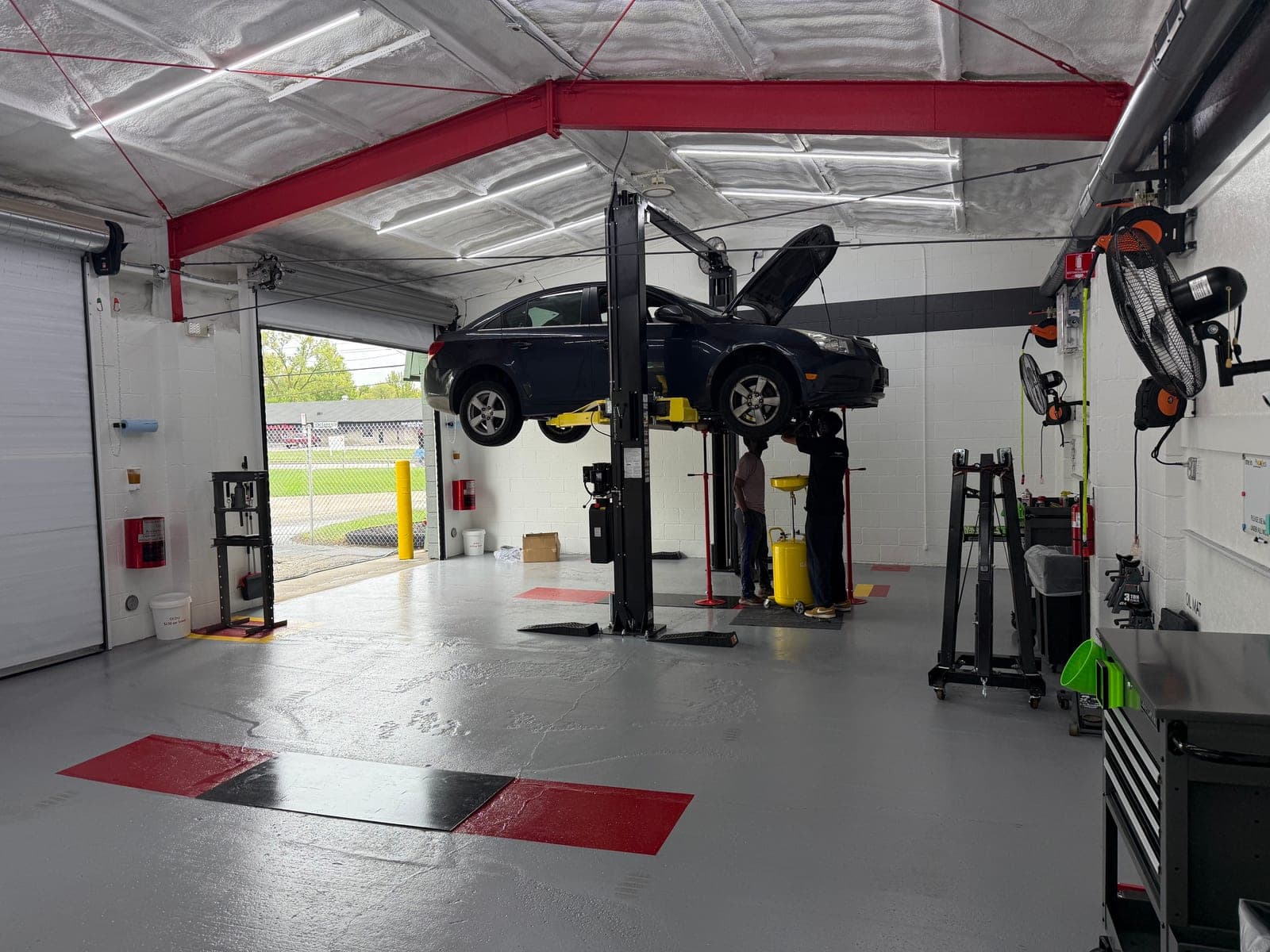 A customer's vehicle on a lift at Coopers Garage