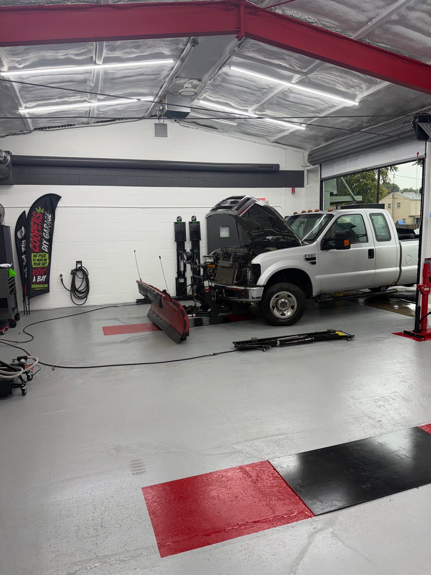 A customer's vehicle on a lift at Coopers Garage