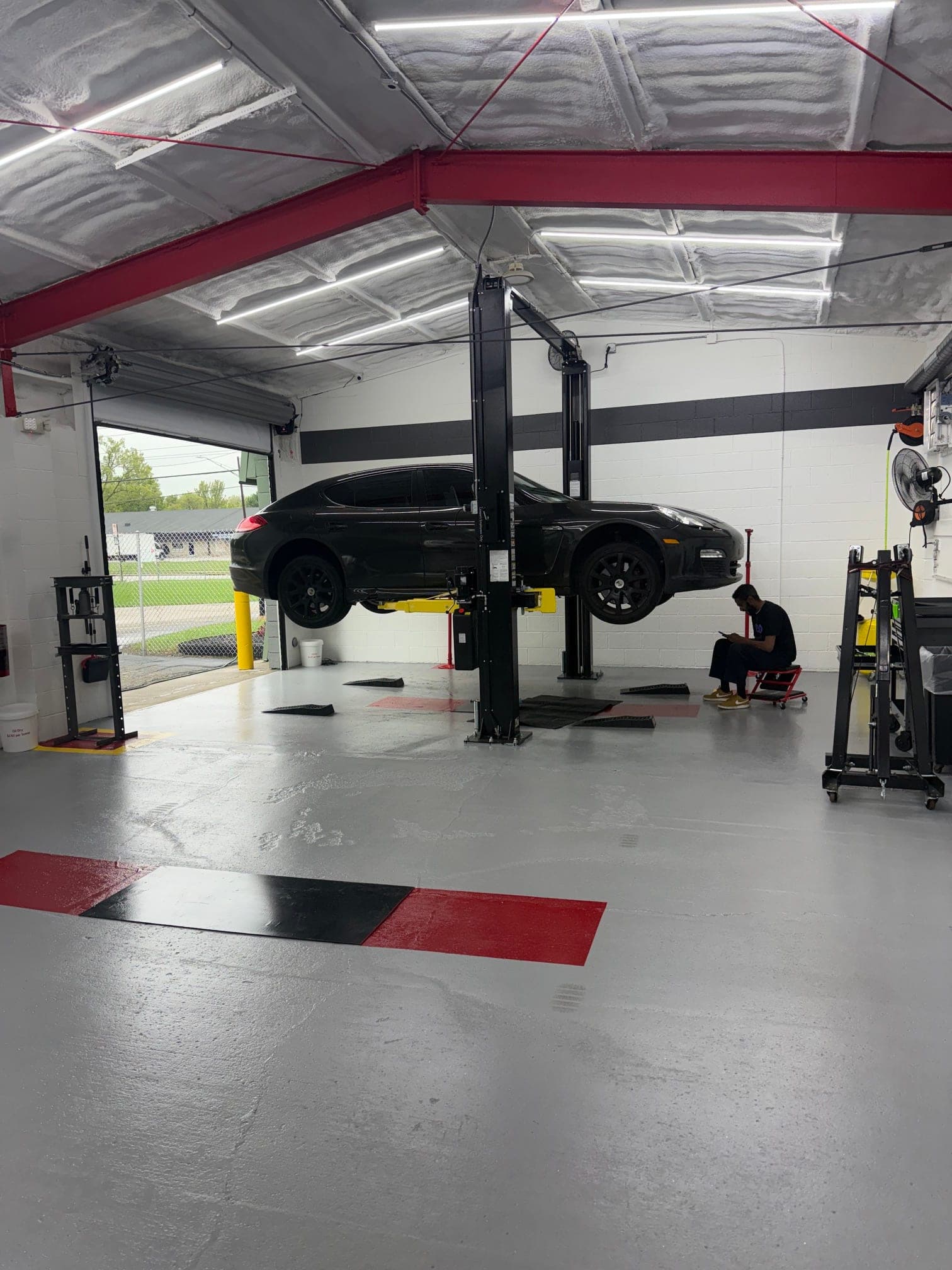 A customer's vehicle on a lift at Coopers Garage