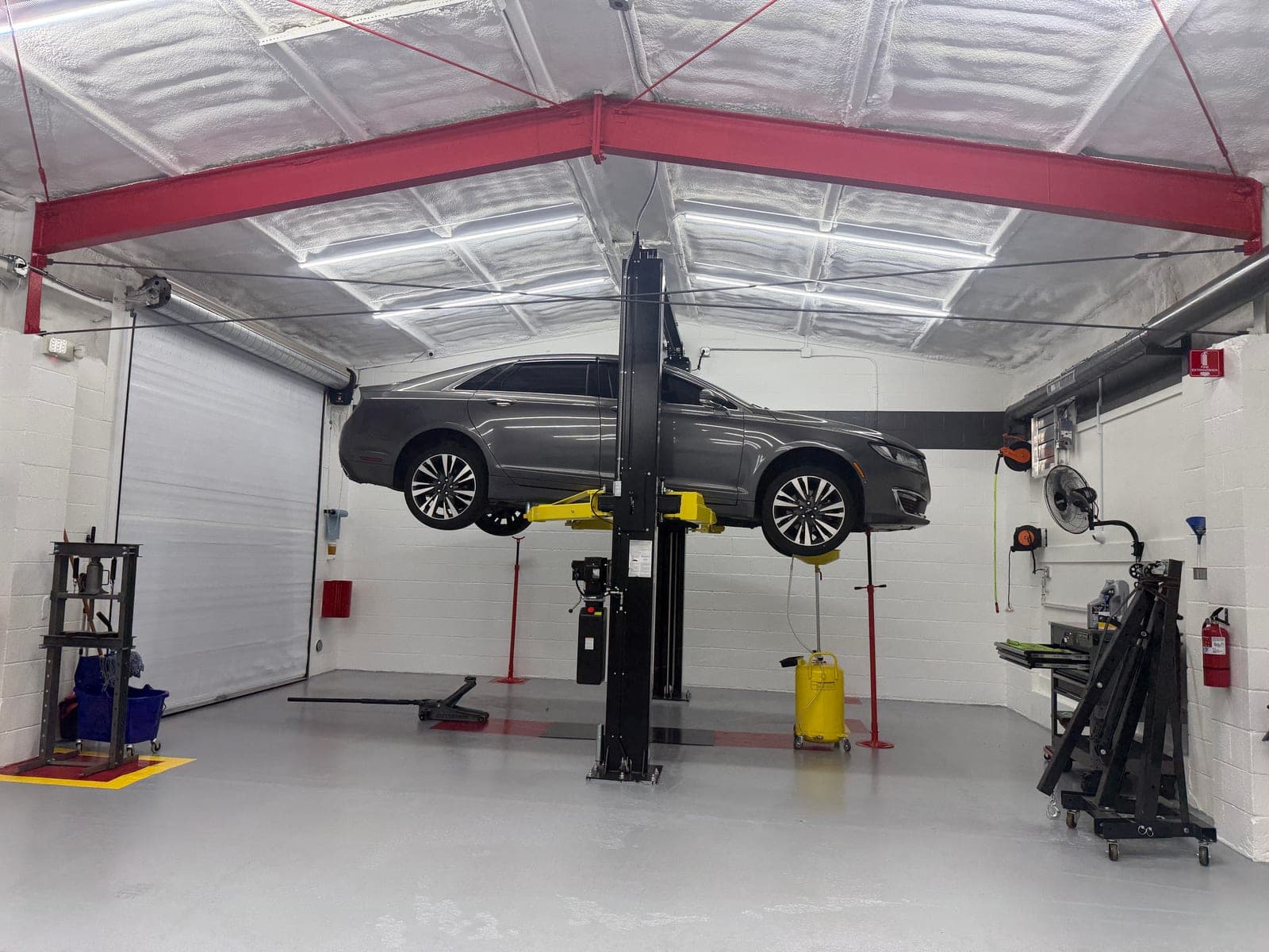 A customer's vehicle on a lift at Coopers Garage